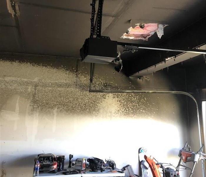 A photo showing a soot covered garage ceiling